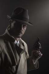 Film noir: detective in the dark with a gun