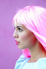 Naklejka premium Young woman with bright pink hair and makeup in profile, expressing modern style and individuality