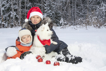 Fototapeta na wymiar mother and son walking with white Spitz dog