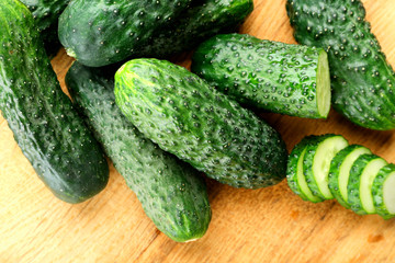 Sliced cucumbers on wooden background
