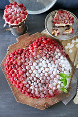 Sweet cake with raspberries on color wooden background