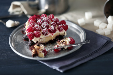 Sweet cakes with raspberries on color wooden background