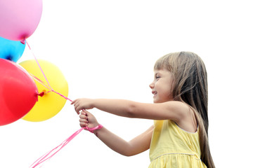 Little girl with balloons outside