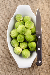 cleaned brussels sprout and knife in a bowl