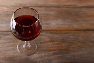 Glass of red wine on wooden table