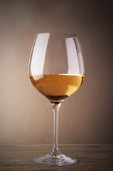 Glass of white wine on wooden table