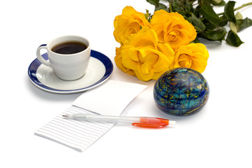 bouquet of yellow roses, coffee, the globe and notebook with the