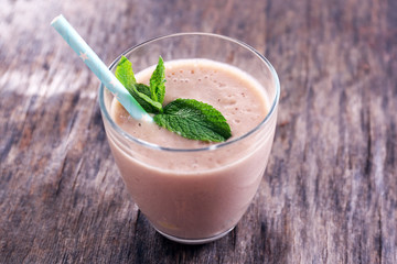 Fresh strawberry yogurt with mint on wooden background