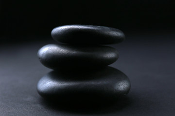 Balanced pebbles on black background