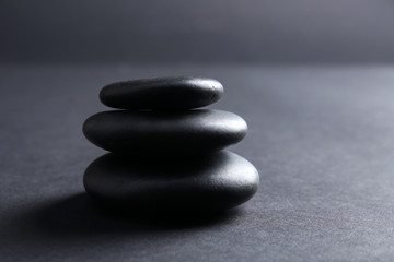 Fototapeta na wymiar Balanced pebbles on dark background