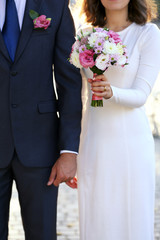 Bride and groom holding wedding bouquet