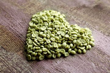 Heart shaped peanuts on wooden background