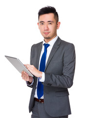 Obraz na płótnie Canvas Young Asian Businessman use of the digital tablet pc