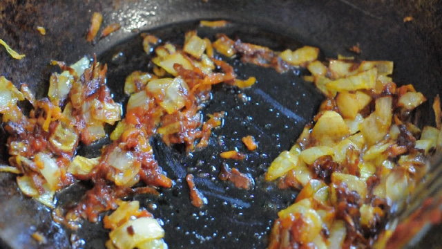 Vegetables with tomatoes souse being fried in a wok