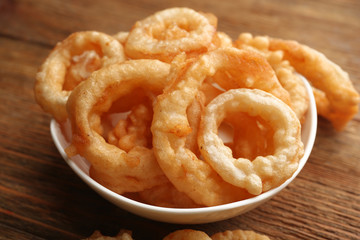 Chips rings in bowl on wooden background