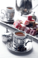 Antique tea-set with Turkish delight on table close-up