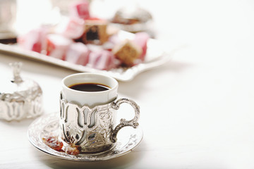 Antique tea-set with Turkish delight on table close-up