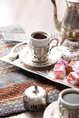 Antique tea-set with Turkish delight on table close-up