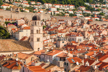 Fototapeta na wymiar Franciscan church with tower bell and roofs of old houses in old town Dubrovnik, Croatia