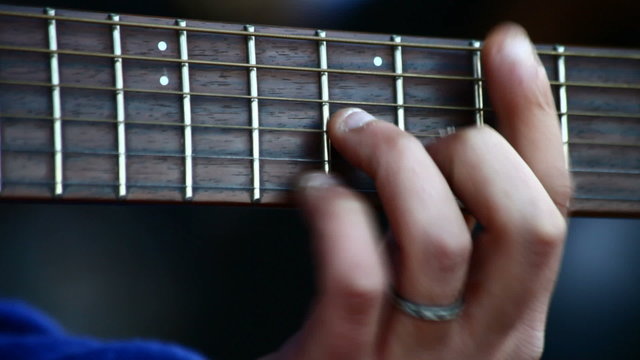 Musician playing electric guitar at live concert - close up