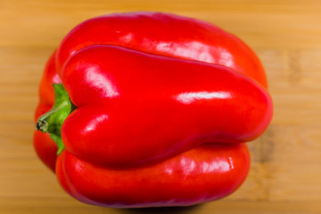 Red bell pepper on wooden table