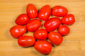 Tomatoes branch on the wood background