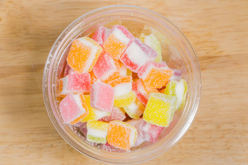 Colorful Gummy candy rainbow on wooden background