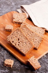Sliced rye bread on cutting board closeup
