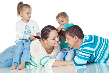 Happy family with kids in studio, white background