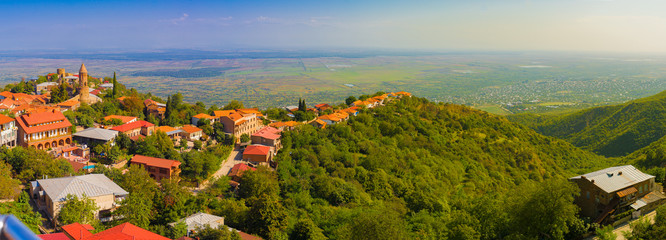 Wide panorama of Sighnaghi and Alazani valley from the hotel Kabadoni, Sighnaghi, Georgia - obrazy, fototapety, plakaty