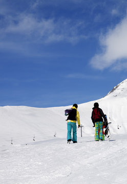 Snowboarders on slope at sun nice day