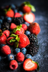 Berry mix on rustic black background