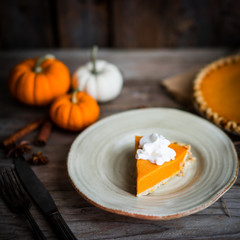 Pumpkin pie on rustic wooden background