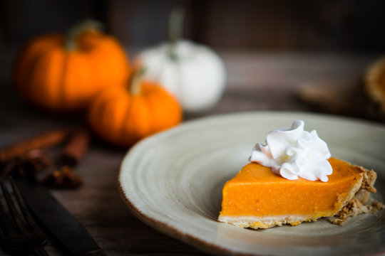 Pumpkin pie on rustic wooden background