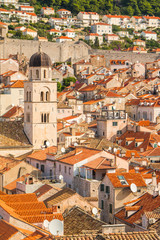     Franciscan church with tower bell and roofs of old houses in old town Dubrovnik, Croatia, panoramic view