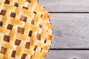 Freshly baked apple pie on a wooden table
