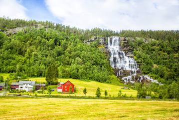 Waterfall Tvindefossen,  Norway. Waterfall Tvindefossen is the largest and highest waterfall of Norway, it is famous for its beauty, its height is 152 m.