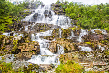 Obraz premium Waterfall Tvindefossen, Norway. Waterfall Tvindefossen is the largest and highest waterfall of Norway, it is famous for its beauty, its height is 152 m.