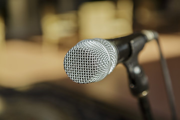 closeup view of microphone detailed head against blurred outdoor background