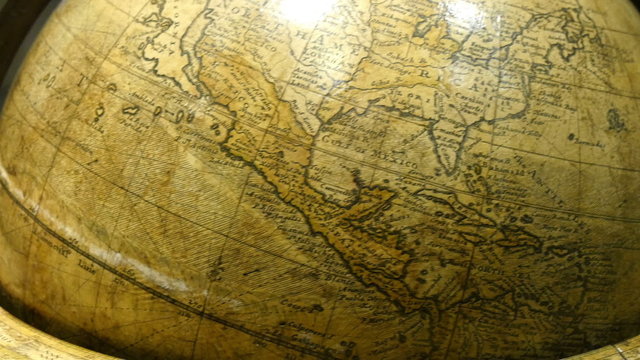 A big brown globe showing the map of North America. This old round globe is used in educational purpose