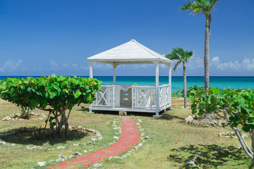 amazing, natural landscape view with beautiful inviting gorgeous massage gazebo near the beach and ocean on sunny warm day