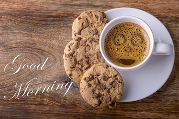 cup of coffee with chocolate cookies on wood and good morning written