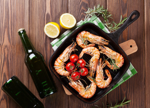 Grilled shrimps on frying pan and beer