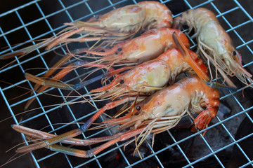Grilled shrimps on the flaming grill