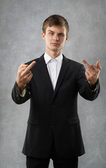 man is showing fingers and smirk