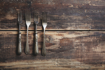 four forks on a wooden table
