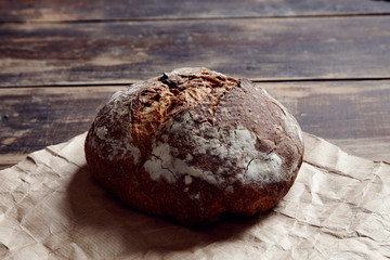 round bread from aside on a wooden table