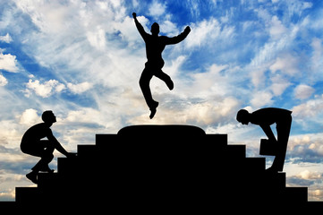 Silhouette of a happy businessman jumping