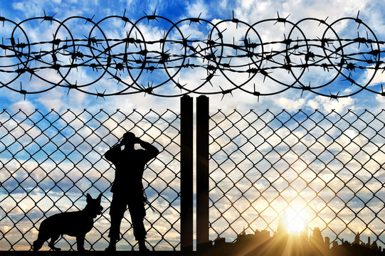 Silhouette of a border guard with a dog