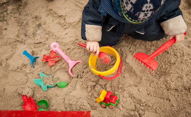 Bright plastic children toys in sandpit or on a beach
